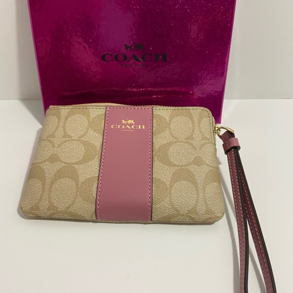 COACH WRISTLET WITH C-SIGNATURE COACH ON IT AND WITH A PINK STRIPE ON FRONT. - Picture 7 of 8